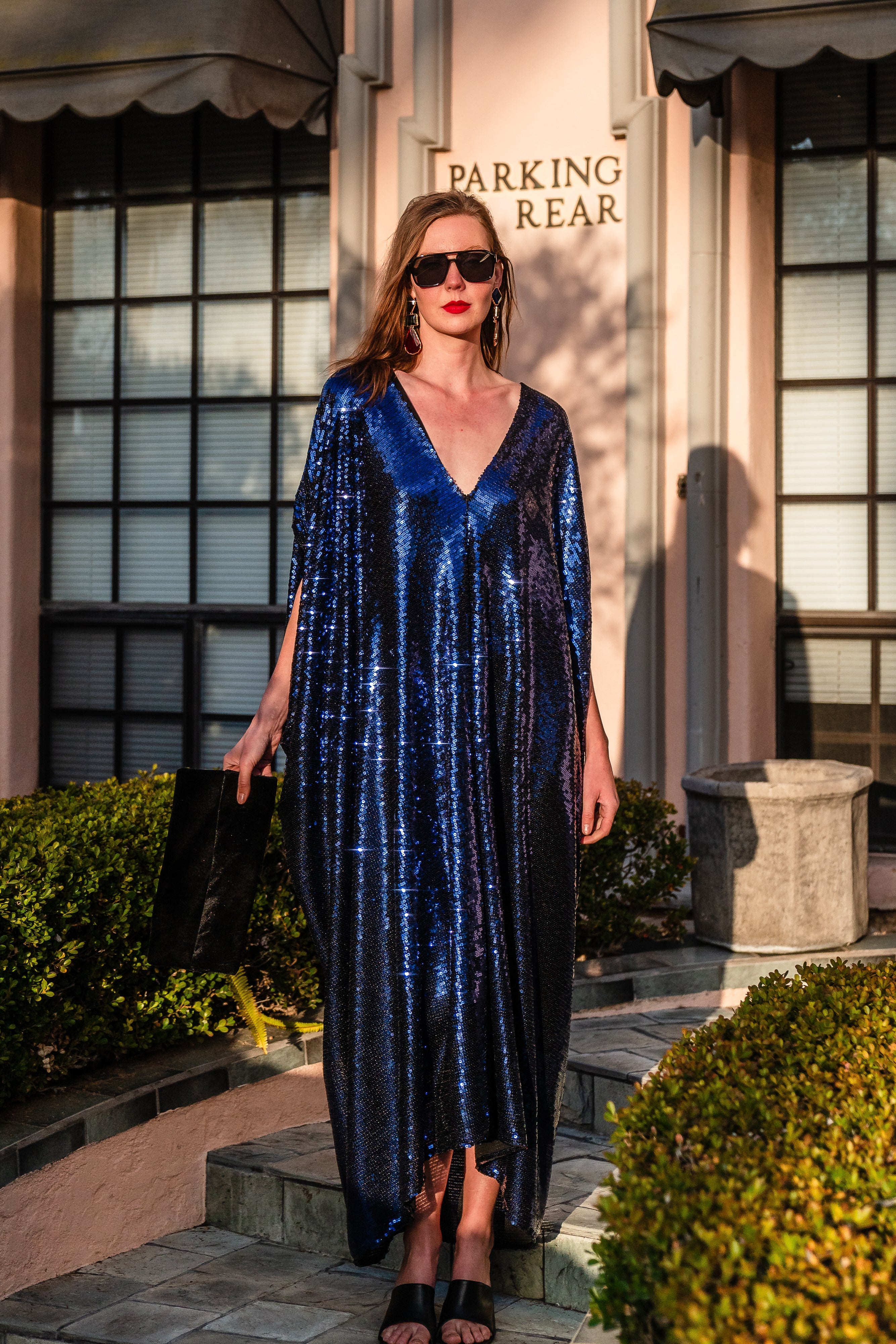 Night sapphire sequin caftan dress by Jennafer Grace featuring shimmering sequins and a flowing, elegant design on a model.