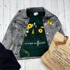 The Graphic Tee No Rain No Flowers short-sleeve graphic T-shirt with floral design on black fabric.