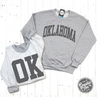 Oklahoma reversible sport grey crewneck sweatshirt by The Graphic Tee, showing front and back design in a casual style.