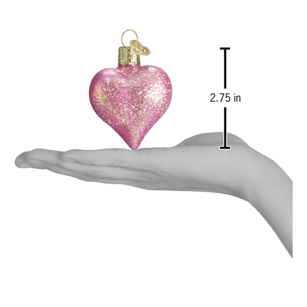 Pink glittered heart ornament from Old World Christmas with sparkling finish and detailed design, perfect for holiday decorations.