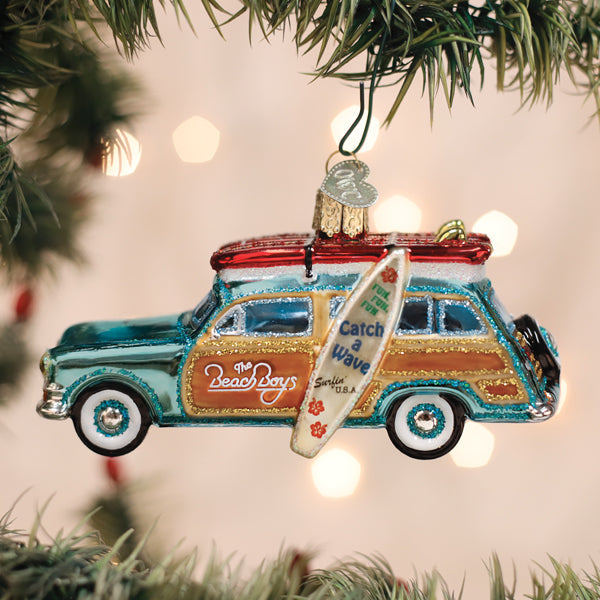 Old World Christmas Surfin' Woody ornament featuring a vintage-style wooden surfer figure with surfboard.