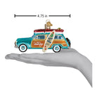 Old World Christmas Beach Boys Surfin' Woody ornament featuring a vintage-style surfing figure on a wooden surfboard.