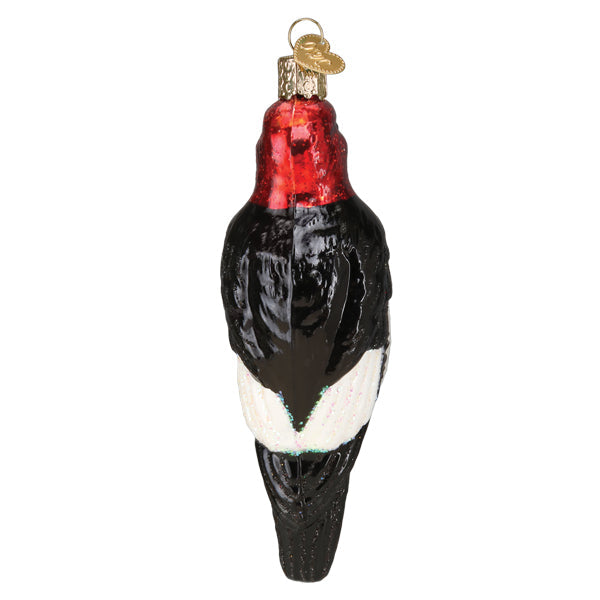 Red-headed Woodpecker ornament by Old World Christmas, detailed glass bird with vibrant red head and realistic features.