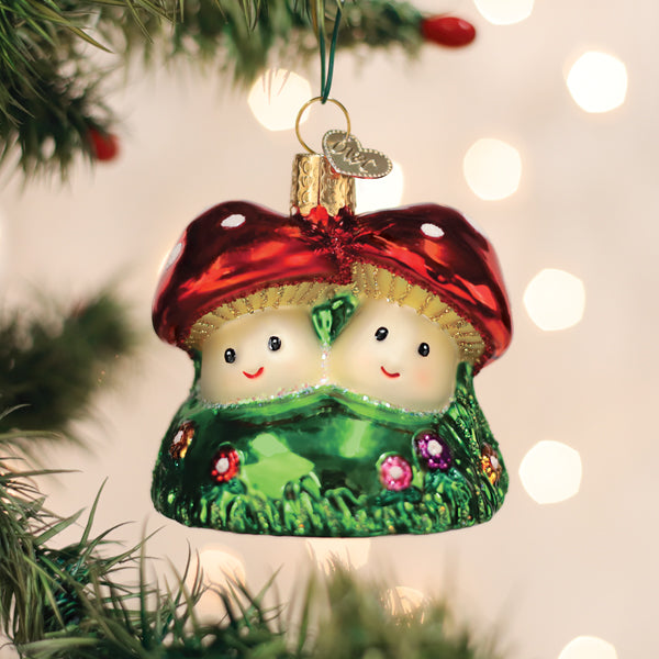Colorful Happy Mushrooms ornament by Old World Christmas featuring whimsical mushroom characters with vibrant red and green caps.