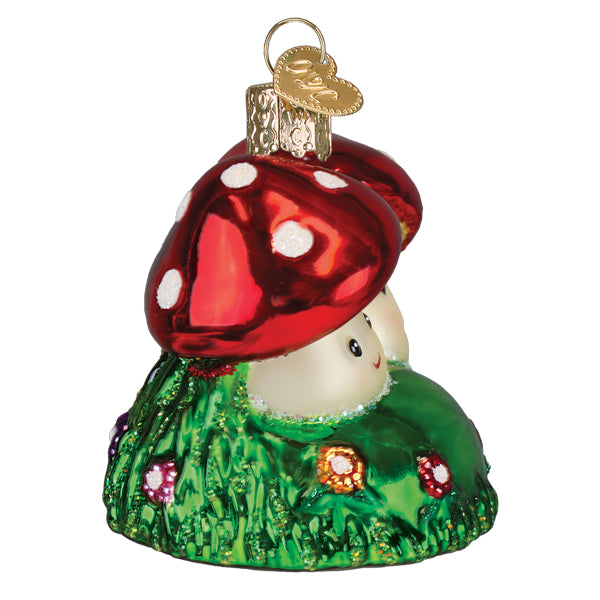 Colorful Happy Mushrooms ornament from Old World Christmas featuring whimsical mushroom characters with vibrant red and green accents.