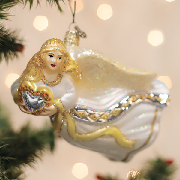 Old World Christmas angel with heart ornament featuring a detailed angel figure holding a heart, perfect for holiday decor.