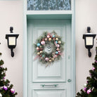 Colorful 24-inch pastel wreath with whimsical accents, crafted by Old World Christmas for festive home decor.