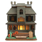Old World Christmas Haunted Mansion ornament featuring a spooky, detailed haunted house with eerie windows and gothic design.