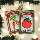 Old World Christmas garden seeds ornament, detailed glass decoration resembling garden seed packets with colorful designs.