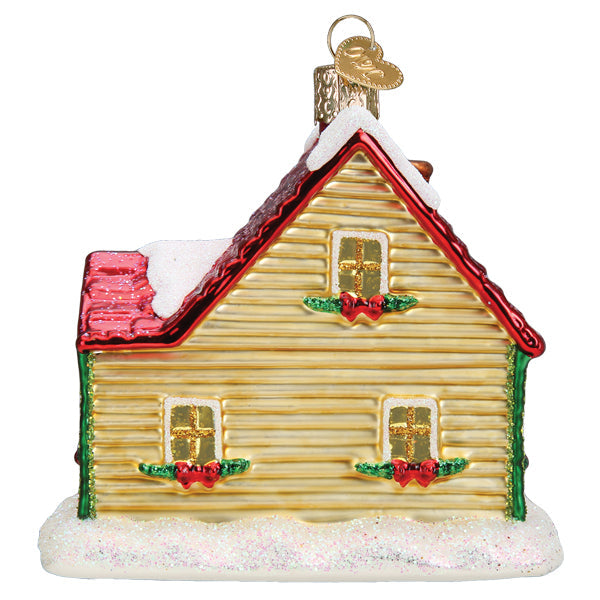 Old World Christmas Christmas Cottage Ornament featuring a detailed, festive ceramic holiday house with snow and holiday decorations.
