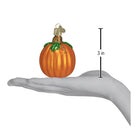 Old World Christmas pumpkin ornament featuring a vibrant orange pumpkin with green stem and festive details.