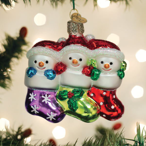 Old World Christmas Snow Family of 3 ornament featuring a snow couple and child, festive holiday decoration in vibrant colors.