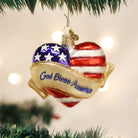 Decorative glass ornament featuring a heart with "God Bless America" inscription by Old World Christmas.