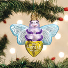 Old World Christmas You Light Up My Life ornament featuring a glowing light bulb and festive holiday design.