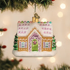 Colorful sugar-coated cottage ornament from Old World Christmas featuring festive holiday details and winter village design.