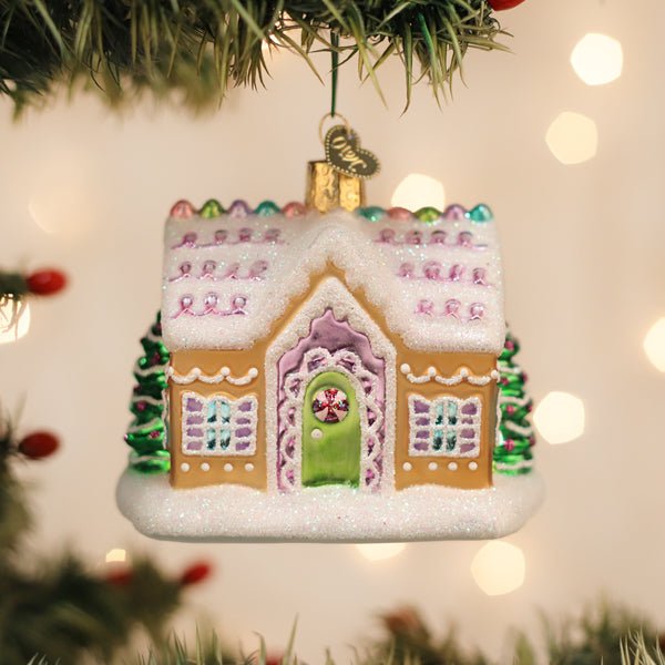 Colorful sugar-coated cottage ornament from Old World Christmas featuring festive holiday details and winter village design.