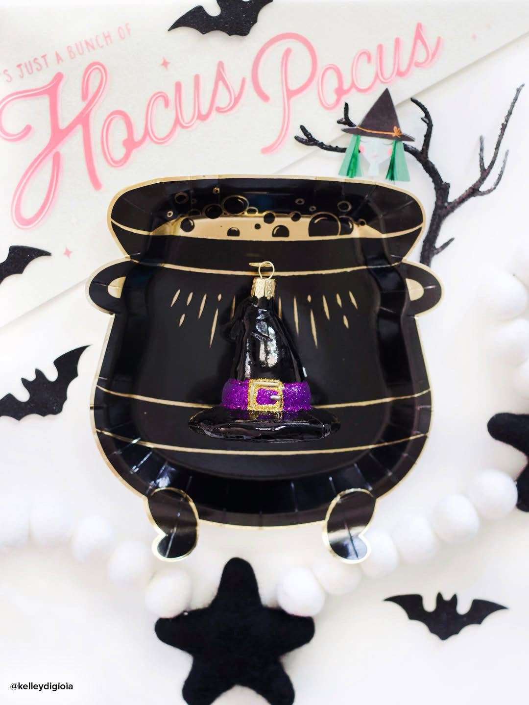 Old World Christmas witch's hat ornament with pointed black hat and festive details, perfect for Halloween or holiday decor.