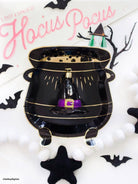 Old World Christmas witch's hat ornament with pointed black hat and festive details, perfect for Halloween or holiday decor.