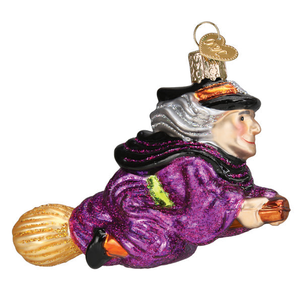 Old World Christmas witch on broomstick ornament featuring a detailed witch figure riding a broomstick.