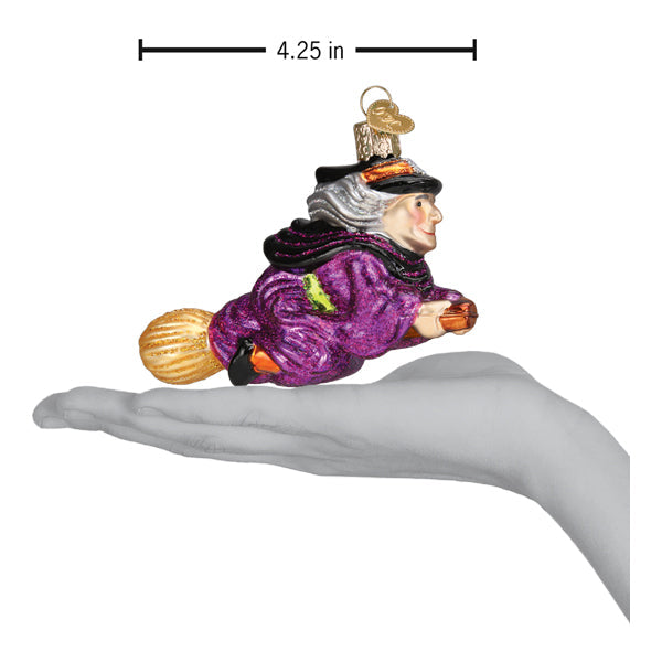 Old World Christmas witch on broomstick ornament featuring a detailed, handcrafted witch figure riding a broomstick.