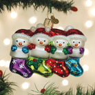 Old World Christmas Snow Family of 4 ornament featuring a festive winter scene with a snow family figurine.