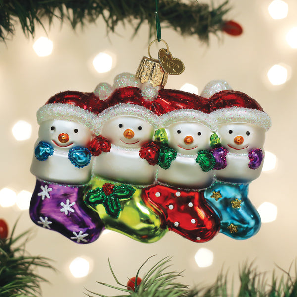 Old World Christmas Snow Family of 4 ornament featuring a festive winter scene with a snow family figurine.