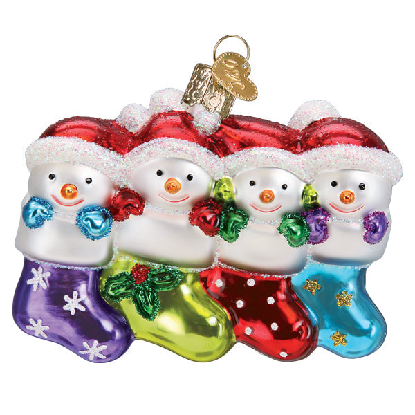 Old World Christmas Snow Family of 4 ornament featuring a festive snow family with winter attire and holiday accessories.