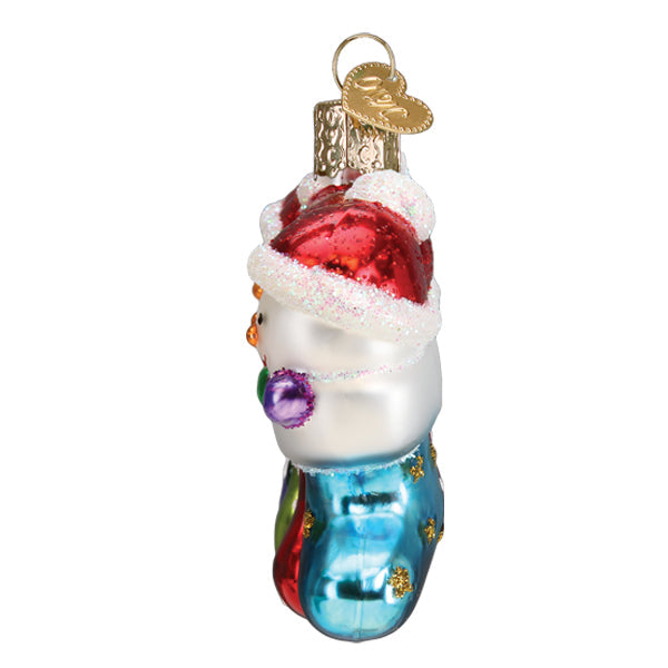 Old World Christmas Snow Family of 4 ornament featuring a festive winter scene with a family of four in holiday attire.