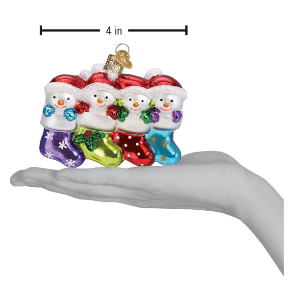 Old World Christmas Snow Family of 4 ornament featuring a festive snow family with winter clothing and holiday decor.