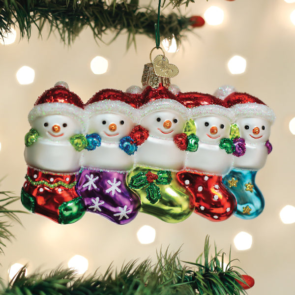 Old World Christmas Snow Family of 5 ornament featuring a festive snow family with winter attire and holiday scene details.