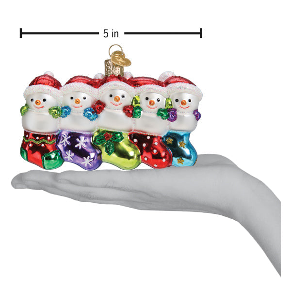 Old World Christmas Snow Family of 5 ornament featuring a festive winter scene with snow-covered figures.