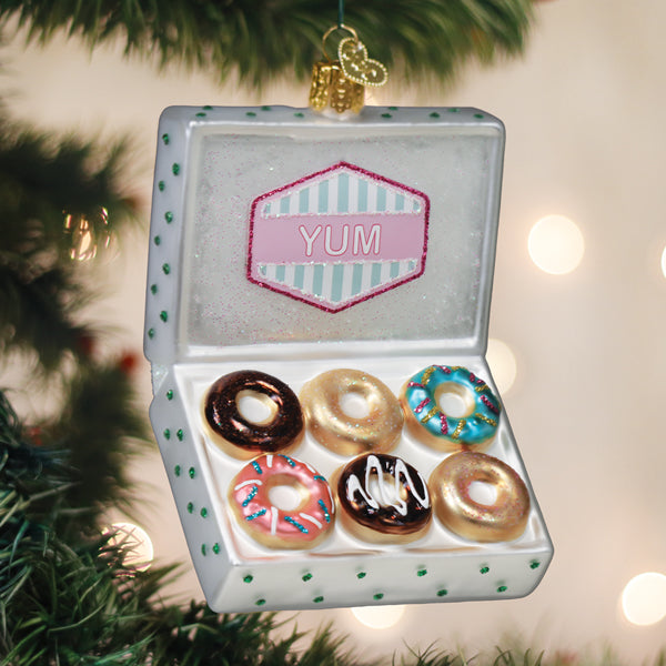 Old World Christmas box of donuts ornament featuring colorful, detailed donut shapes in a festive display.