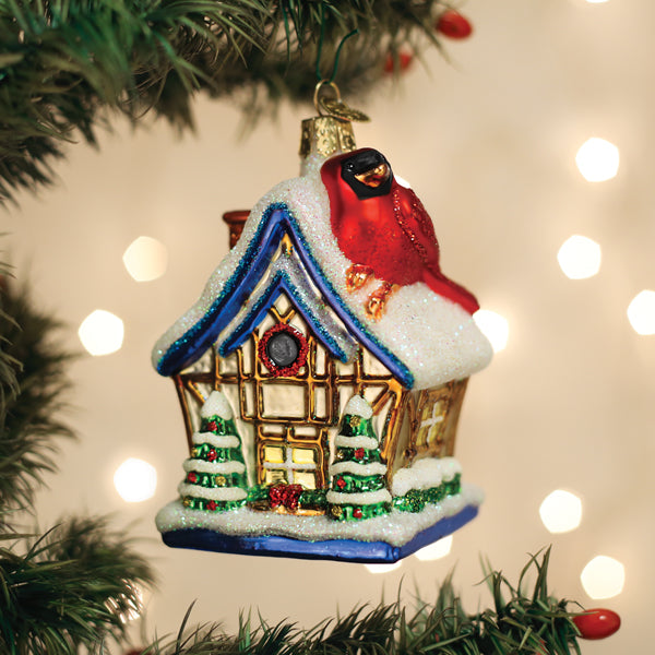 Old World Christmas Cardinal Birdhouse Ornament featuring a detailed red cardinal perched on a miniature birdhouse.