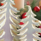 Set of six iridescent ceramic Christmas trees from Old World Christmas, featuring shiny, colorful decorative holiday ornaments.