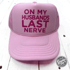 Foam trucker cap with "On My Husband's Last Nerve" slogan, casual accessory by The Graphic Tee featuring adjustable fit