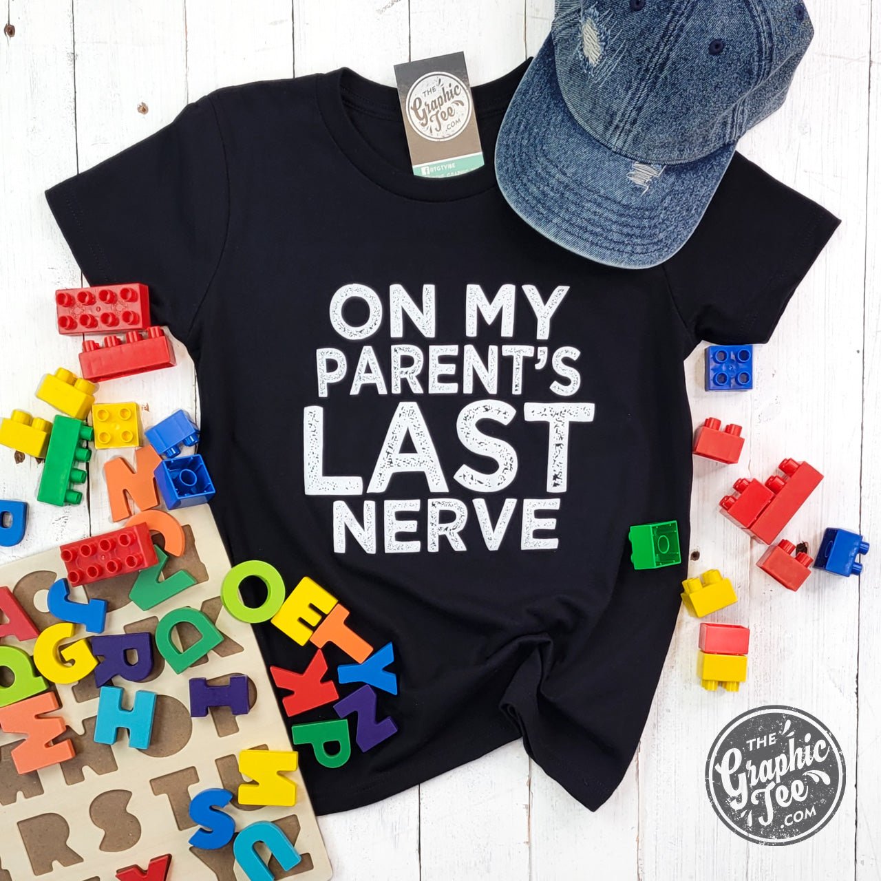 Youth SS Graphic Tee from The Graphic Tee featuring humorous "On My Parent's Last Nerve" print on soft fabric.