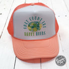 Coral and white foam trucker cap by The Graphic Tee, featuring a casual and stylish design with adjustable fit.
