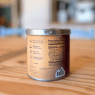 Ora Cacao Triple Fat Cacao Powder in a 12 oz tin, showing the dark chocolate cacao powder inside the container.
