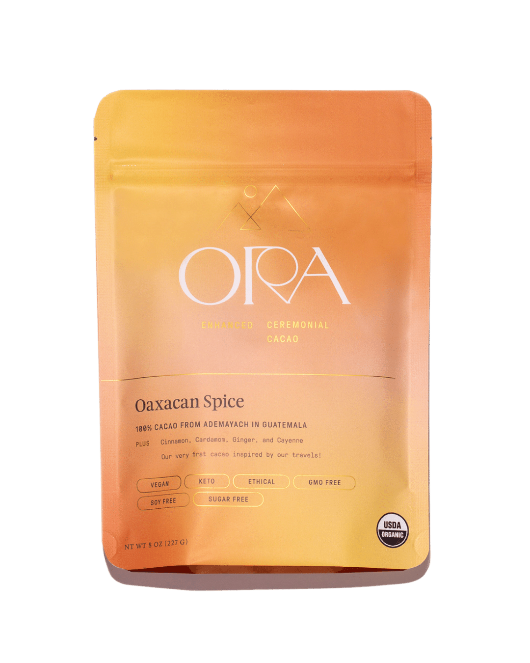 Ora Cacao Oaxacan Spice enhanced 100% ceremonial cacao in a 1 lb package, highlighting rich, dark cacao beans with spice accents.