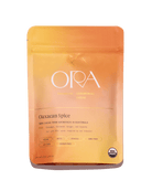 Ora Cacao Oaxacan Spice enhanced 100% ceremonial cacao in a 1 lb package, highlighting rich, dark cacao beans with spice accents.