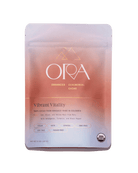 Bag of Ora Cacao Vibrant Vitality Enhanced 100% Ceremonial Cacao in a 1 lb package, showing the product label and cacao pieces.