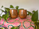 Ora Cacao Cups by Ora Cacao featuring smooth, dark chocolate cups filled with rich cacao filling on a rustic wooden surface.
