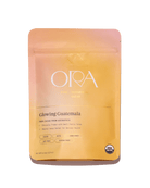 Pure 100% ceremonial cacao from Ora Cacao, Glowing Guatemala, in a 1 lb package showing rich cacao beans and packaging.