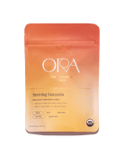 Pure 100% ceremonial cacao from Tanzania by Ora Cacao, shown in a 1 lb package, highlighting rich cacao beans and natural processing.