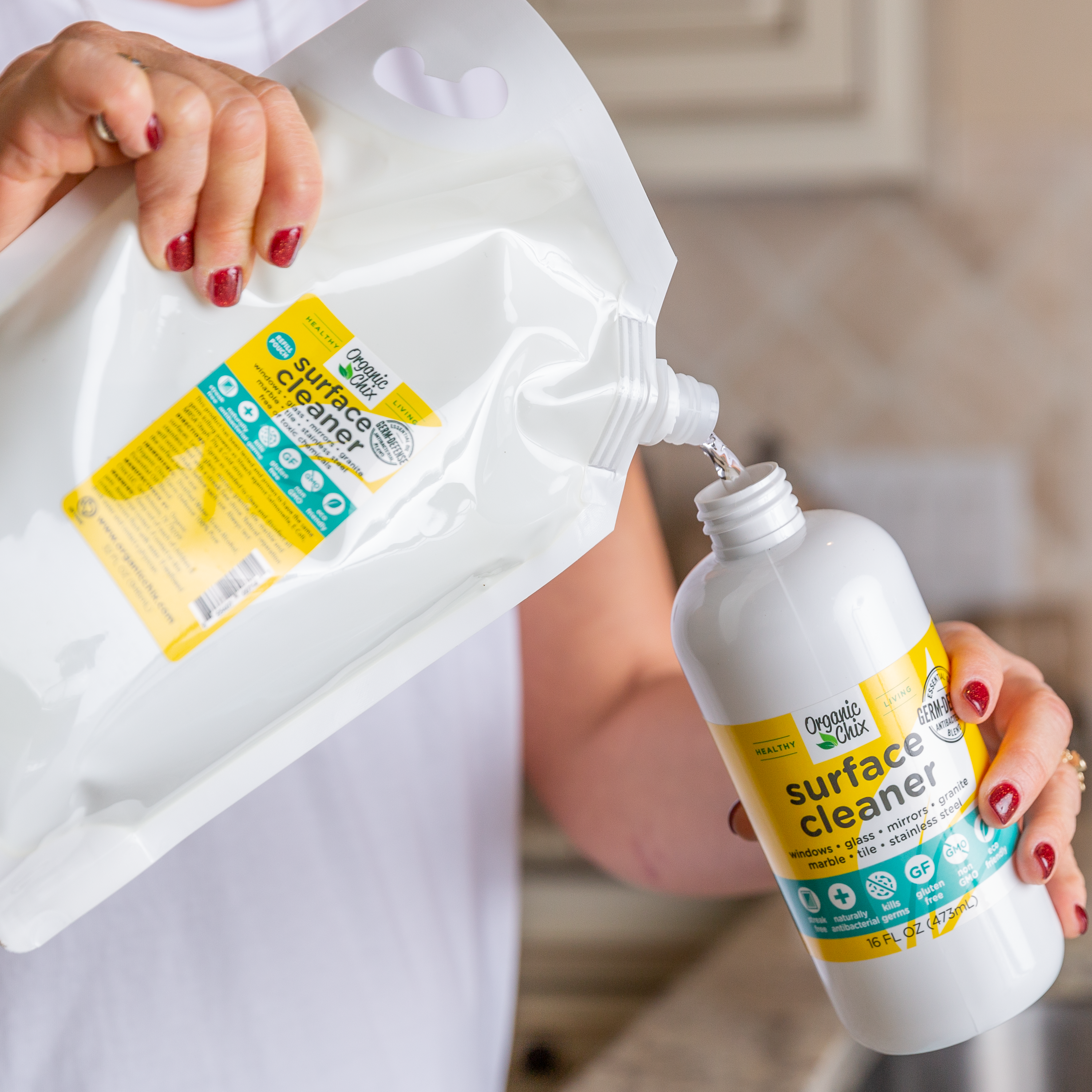 Organic Chix all-purpose surface cleaner with refill option, showcasing a spray bottle and cleaning surface for healthy cleaning.