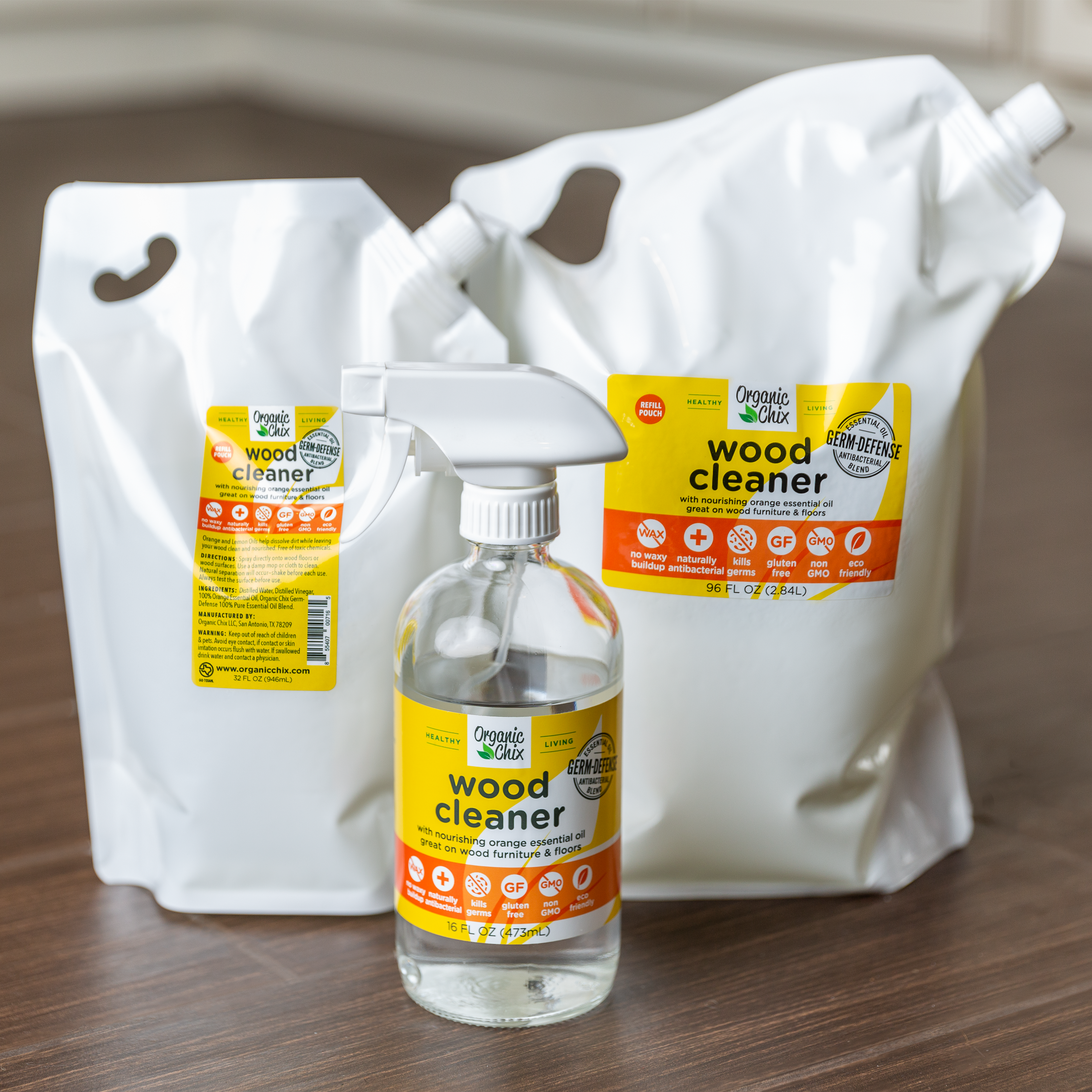 Organic Chix natural non-toxic wood cleaner spray showing a bottle with fresh wood surface in the background.