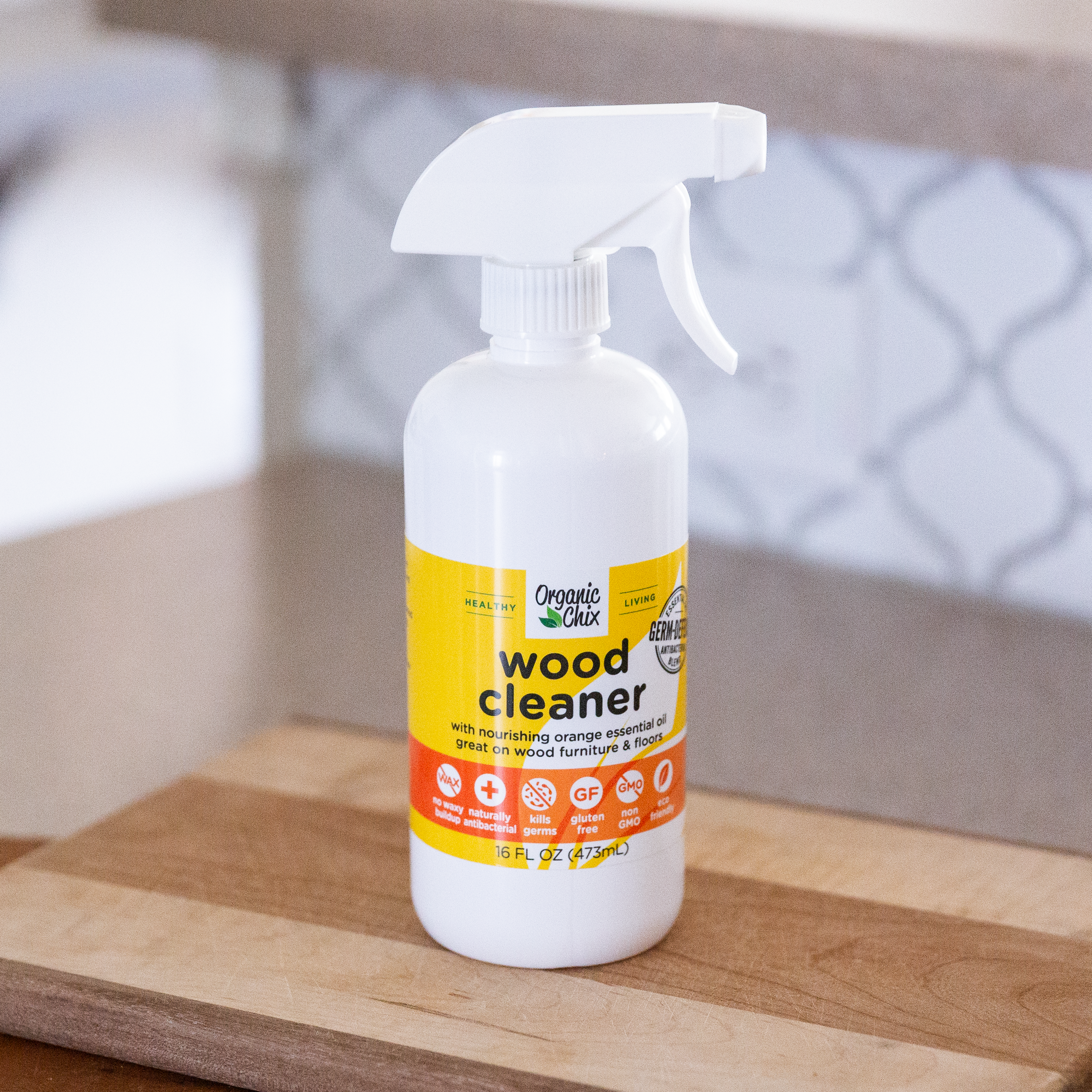 Organic Chix natural non-toxic wood cleaner in a spray bottle, showcasing a clean, polished wooden surface for healthy cleaning.