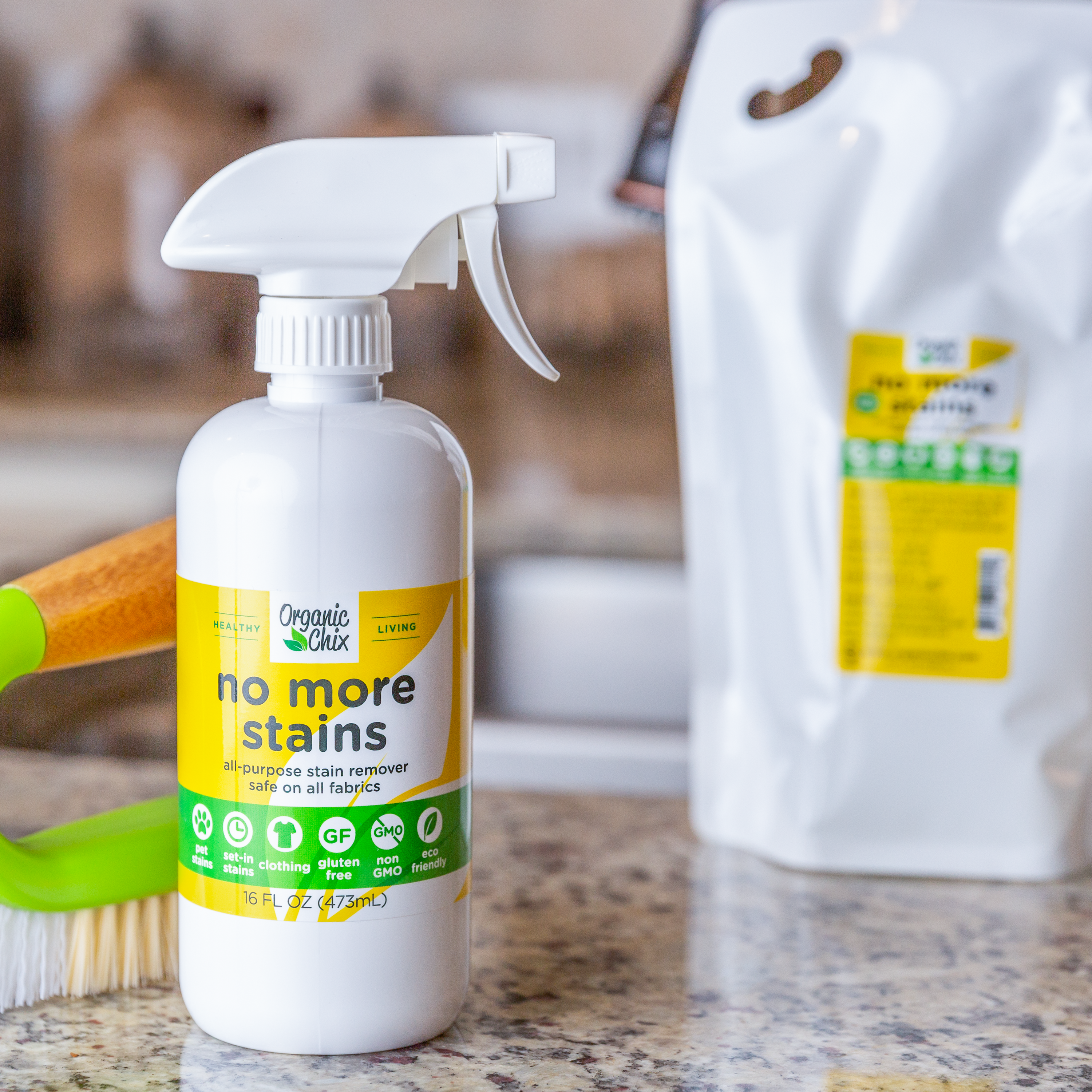 Organic Chix Natural Non-Toxic Stain Remover for healthy laundry, featuring a clear spray bottle with label and stain removal liquid.