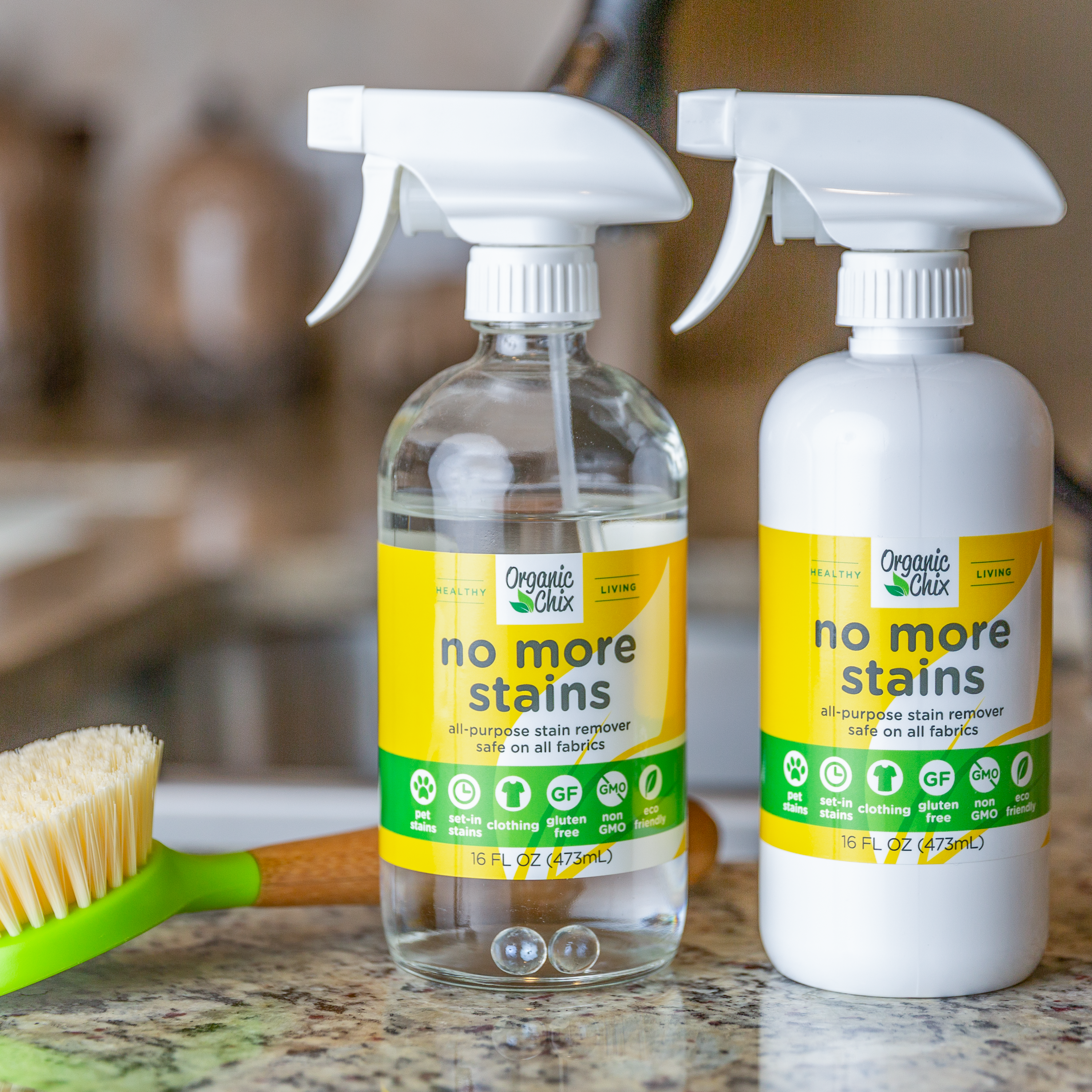 Organic Chix Natural Non-Toxic Stain Remover for healthy laundry, showing a clear spray bottle with label and stains being treated.
