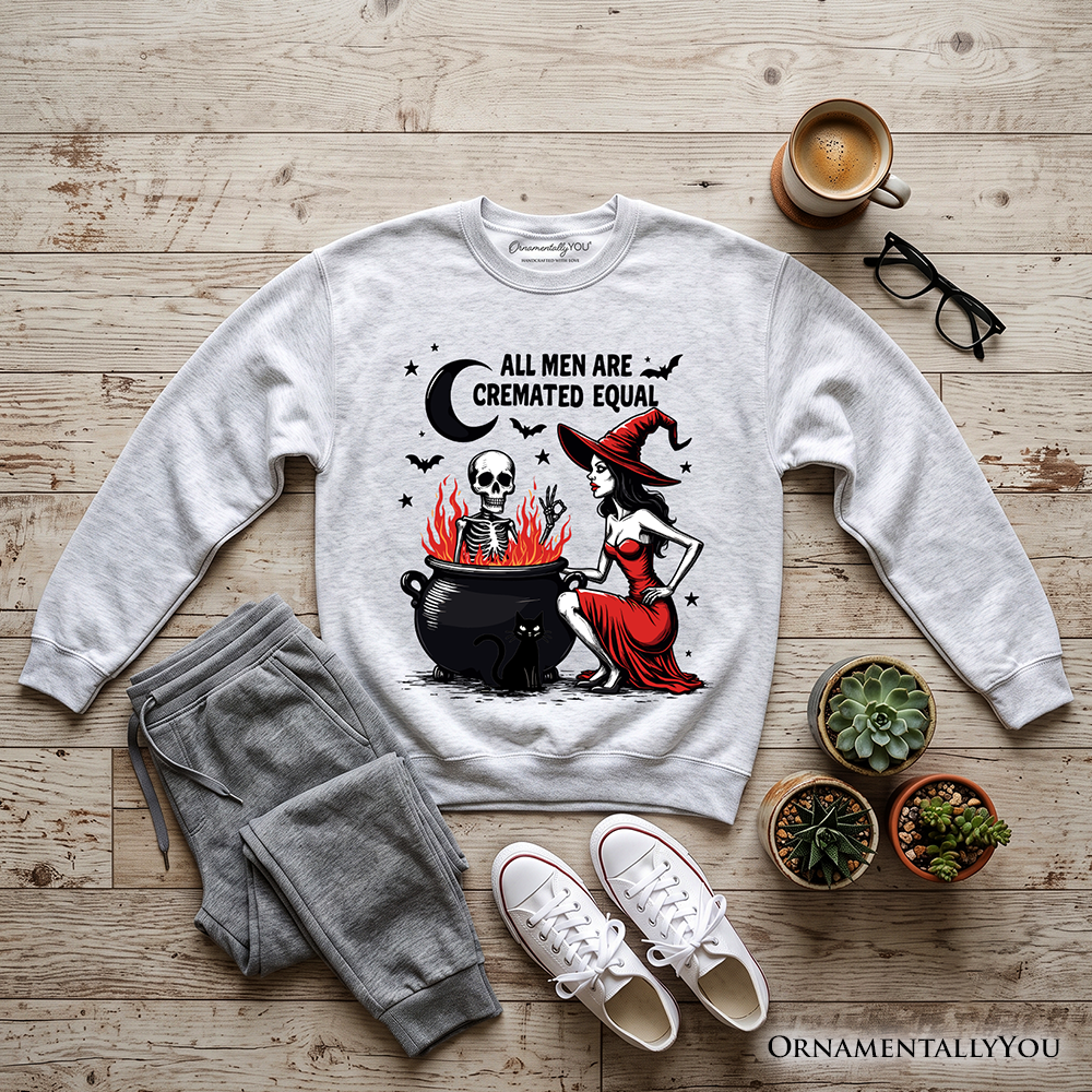 Funny Halloween sweatshirt by OrnamentallyYou featuring ash-colored fabric and witch-themed design with humorous "All Men Are Cremated Equal" slogan.